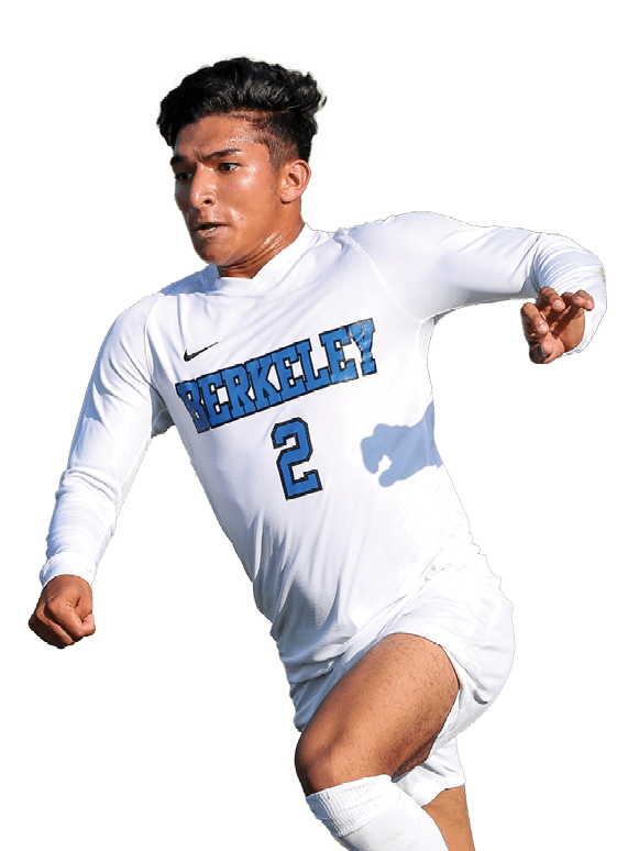 A Berkeley College student wearing a white Berkeley sports uniform with the number 2 is playing soccer with a focused expression. 